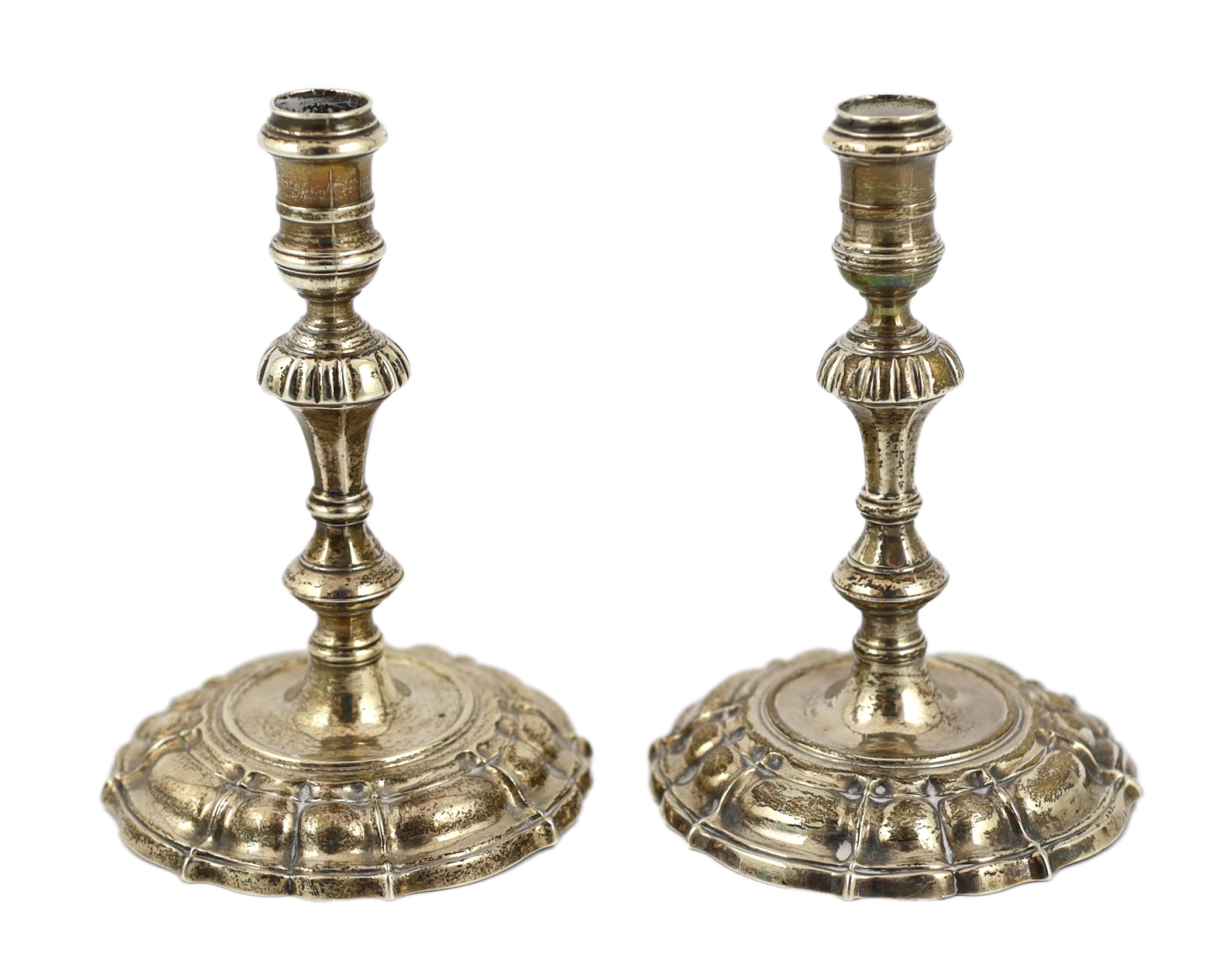 A pair of George II cast silver tapersticks, by James Gould